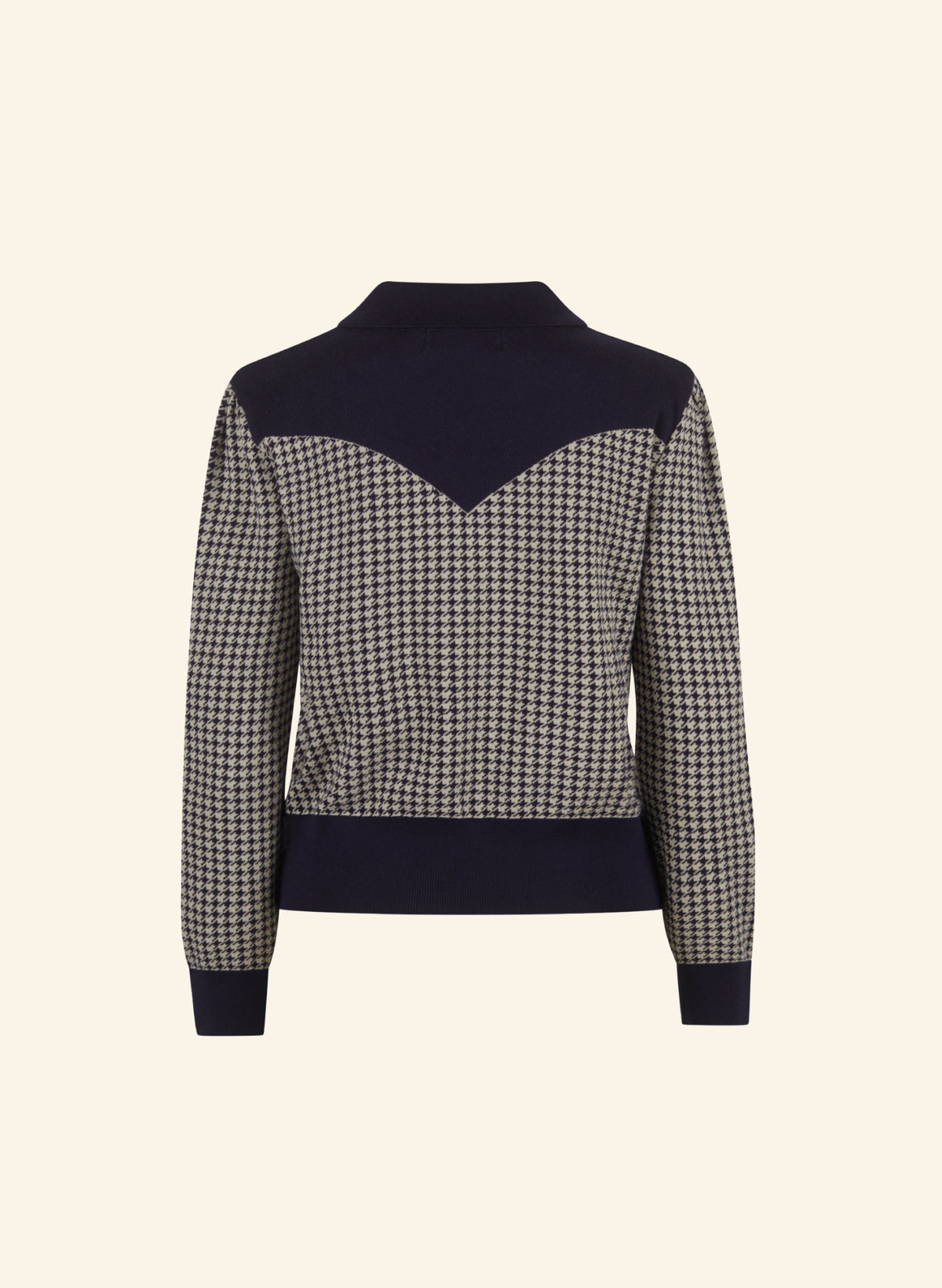A women's knit sweater with a houndstooth pattern on the body and sleeves, contrasted with solid navy blue panels at the collar, underarm, and hem, and matching navy cuffs.