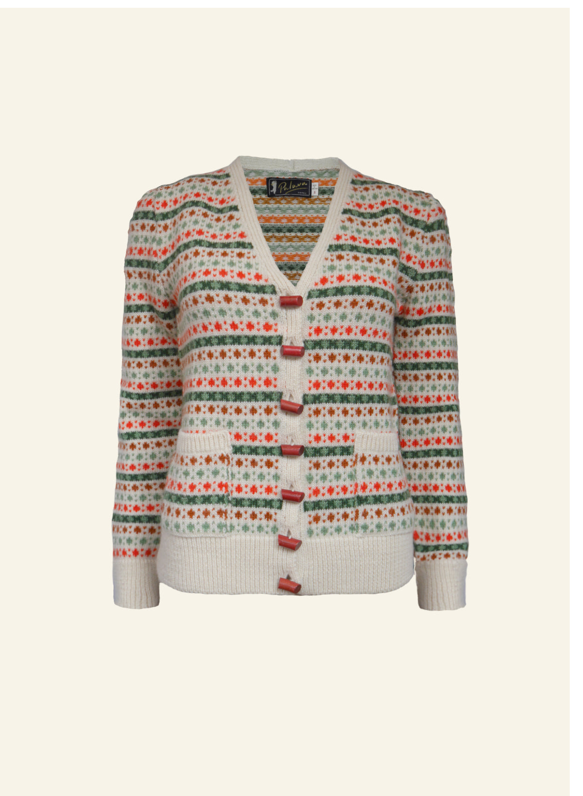 A cream Heritage, 1950s-style cardigan made from 100% British wool with popcorn knit pattern and red lipstick buttons.