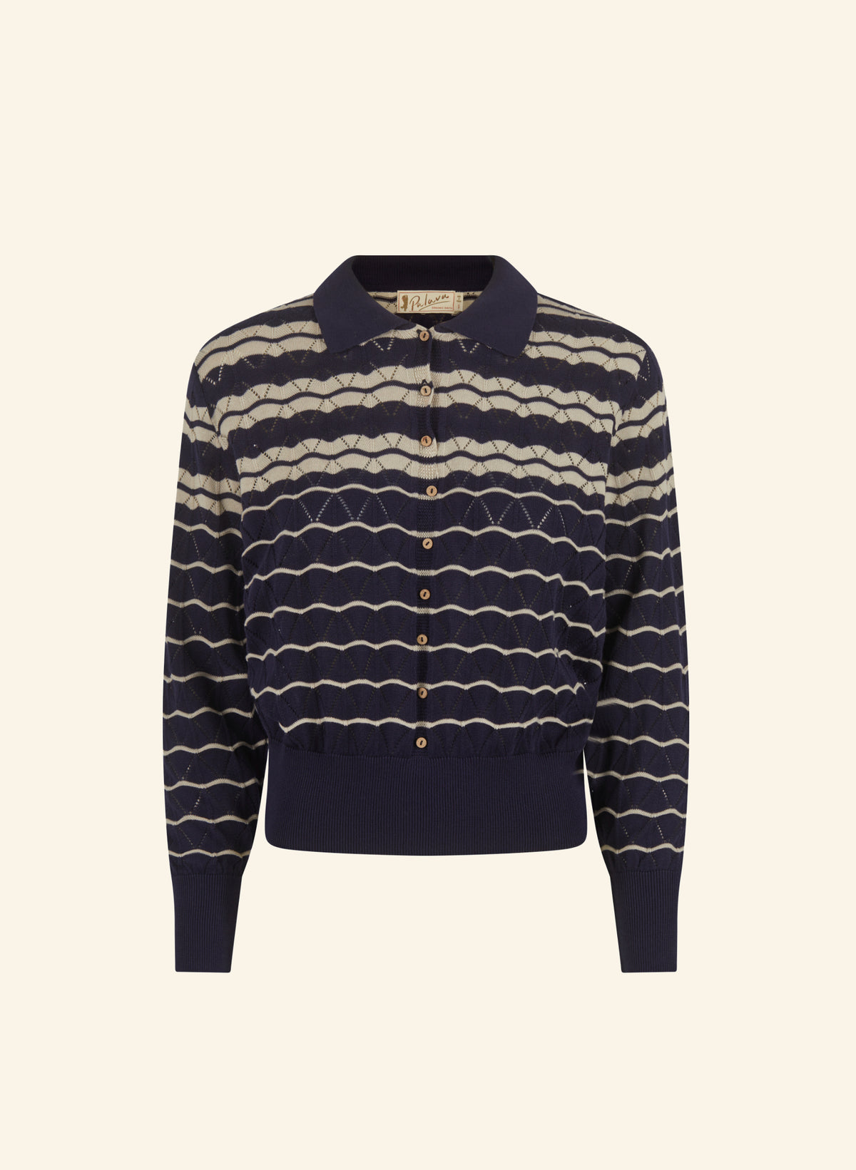 A navy blue knit polo cardigan featuring horizontal wavy cream stripes and a button-up front, displayed against a solid light beige background.