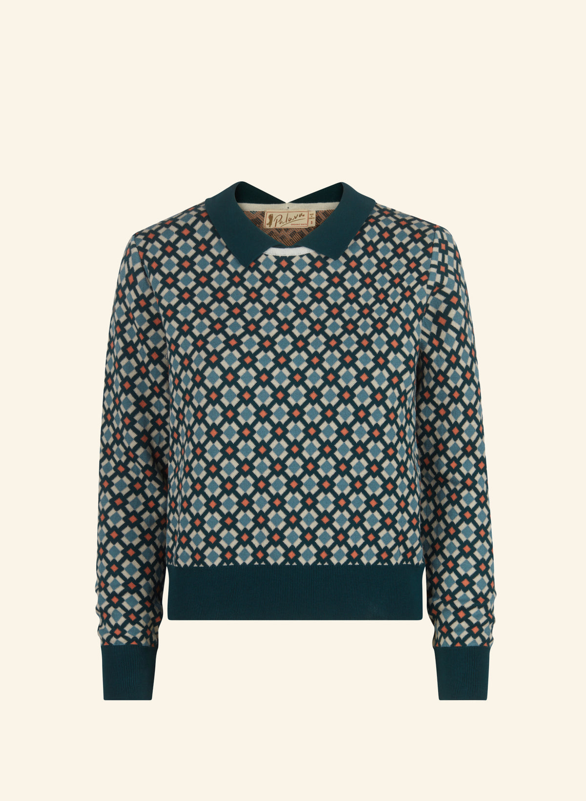 A long-sleeve knit sweater with a dark teal collar, cuffs, and hem, featuring an all-over geometric diamond pattern in navy, teal, and cream.