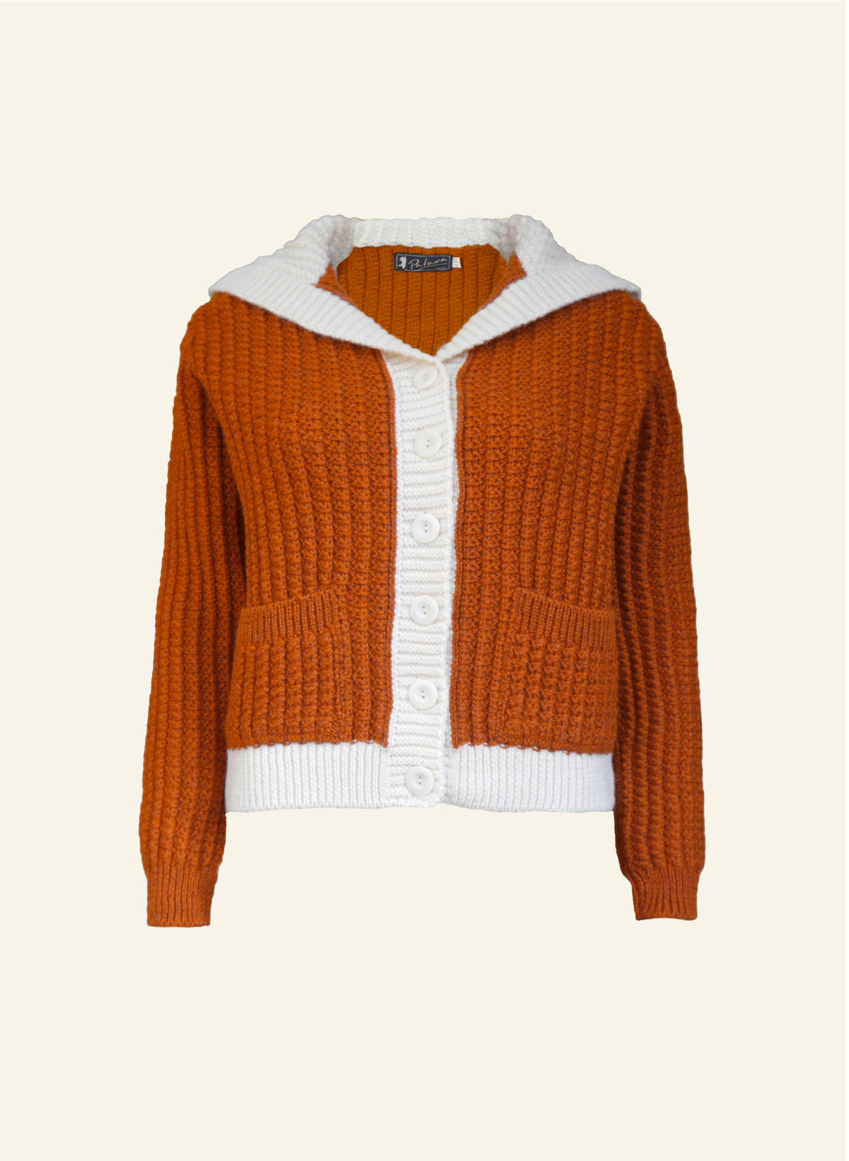 A Corvette rust orange cardigan with cream collar and pockets, made from 100% British wool, displayed against a neutral background.