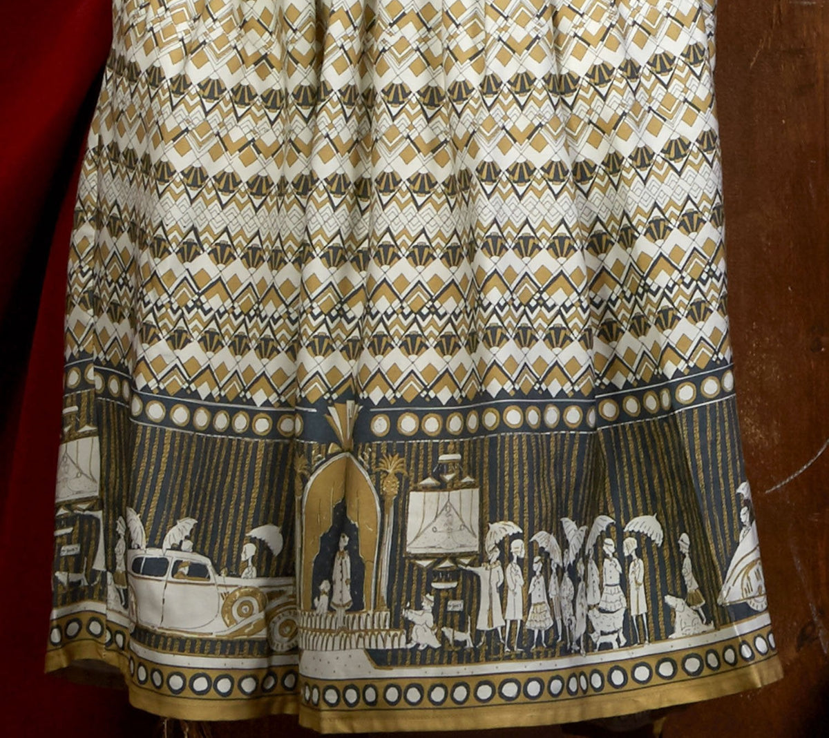 100% Tencel Lyocell vintage-style cream knee-length belted shirt dress with 3/4 length sleeves, pockets, and a moving pictures print inspired by the cinema.